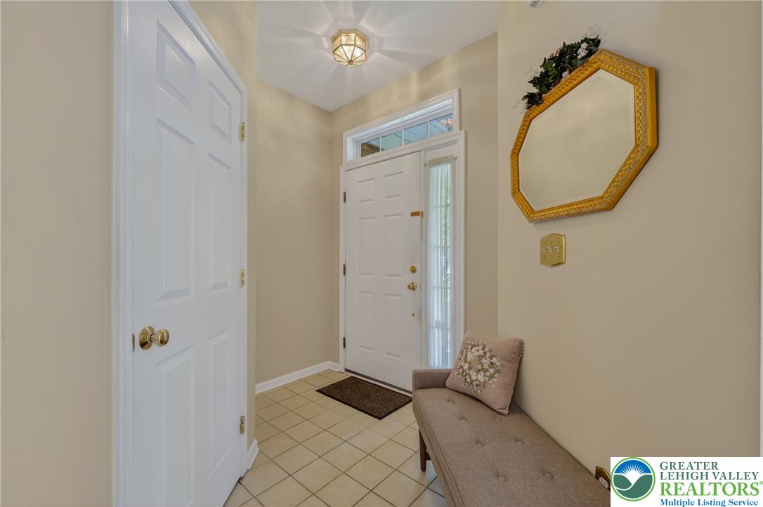 4345 Creek Road Allentown, PA 18104 - Photo 6 of 33 A welcoming entryway with tiled flooring and a bright transom window above the front door.