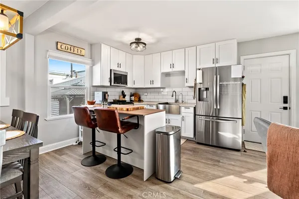 a kitchen with granite countertop a sink a stove and cabinets