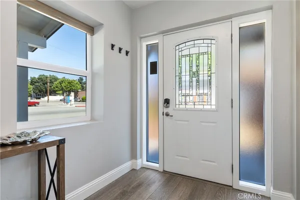 a view of a livingroom with wooden floor and a window