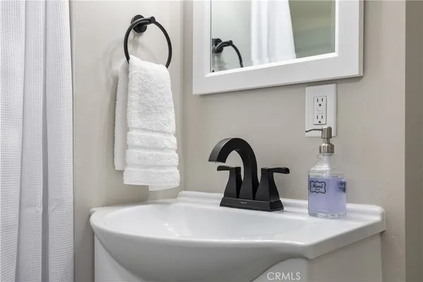 a bathroom with a sink and mirror