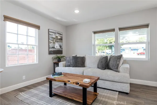 a living room with furniture a table and a window