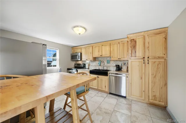 a kitchen with stainless steel appliances granite countertop a stove microwave and cabinets
