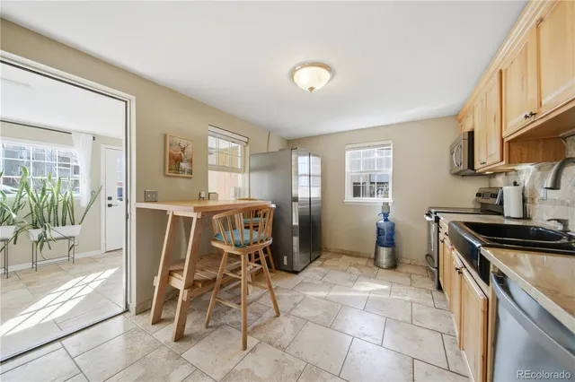 a kitchen with a stove top oven and cabinets