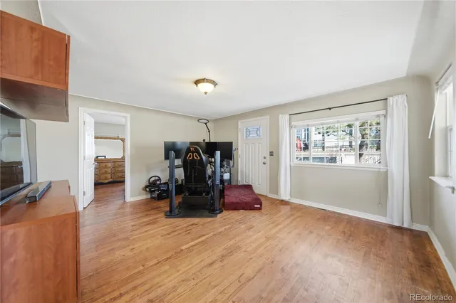 a view of a workspace with furniture and wooden floor