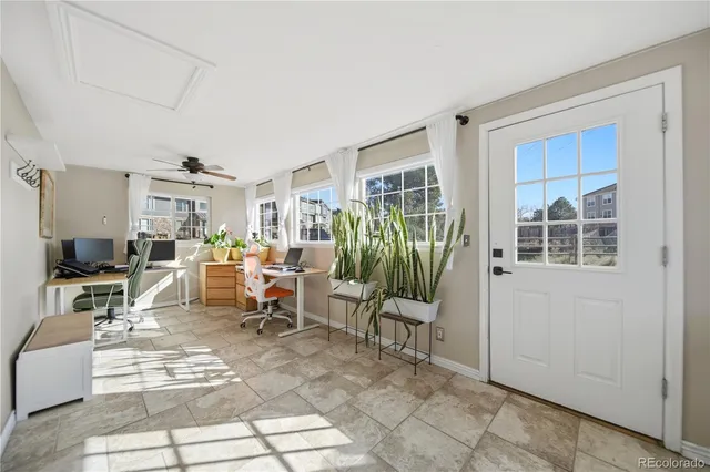 a work room with furniture and potted plants