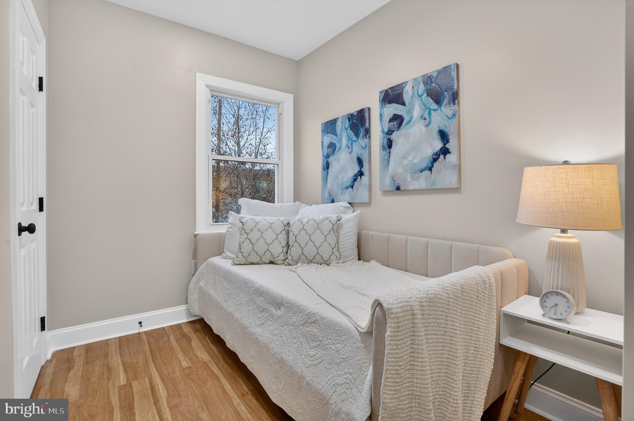 212 36th Street Northeast, Unit 3 Washington, DC 20019 - Photo 12 of 15 a bedroom with a bed and a window
