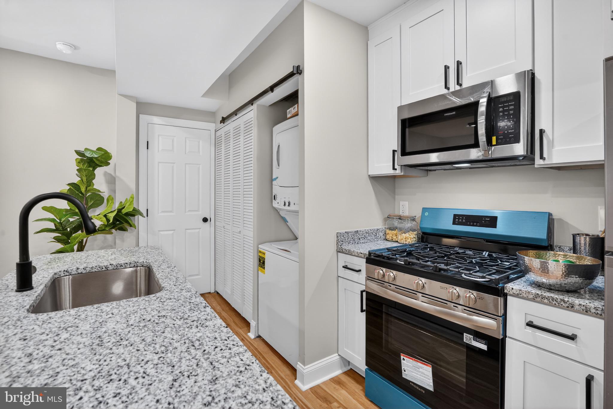 212 36th Street Northeast, Unit 3 Washington, DC 20019 - Photo 5 of 15 a kitchen with stainless steel appliances kitchen island a stove and a sink