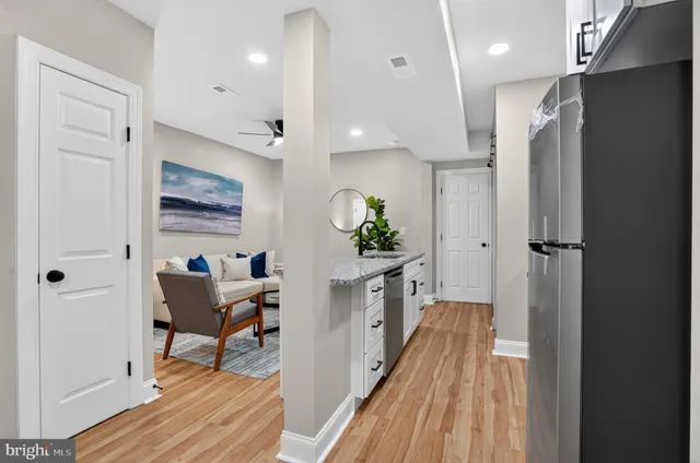 a view of a hallway to a livingroom and a dinning room