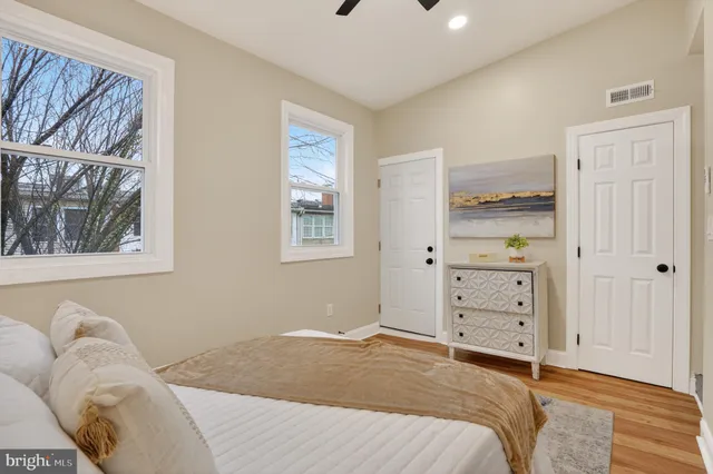 a bedroom with a bed and a window