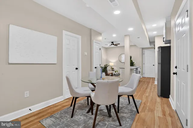 a view of a dining room with furniture and wooden floor