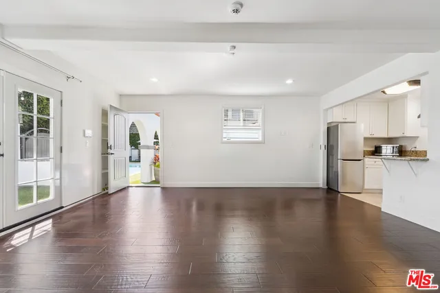 a kitchen with granite countertop white cabinets stainless steel appliances and a sink