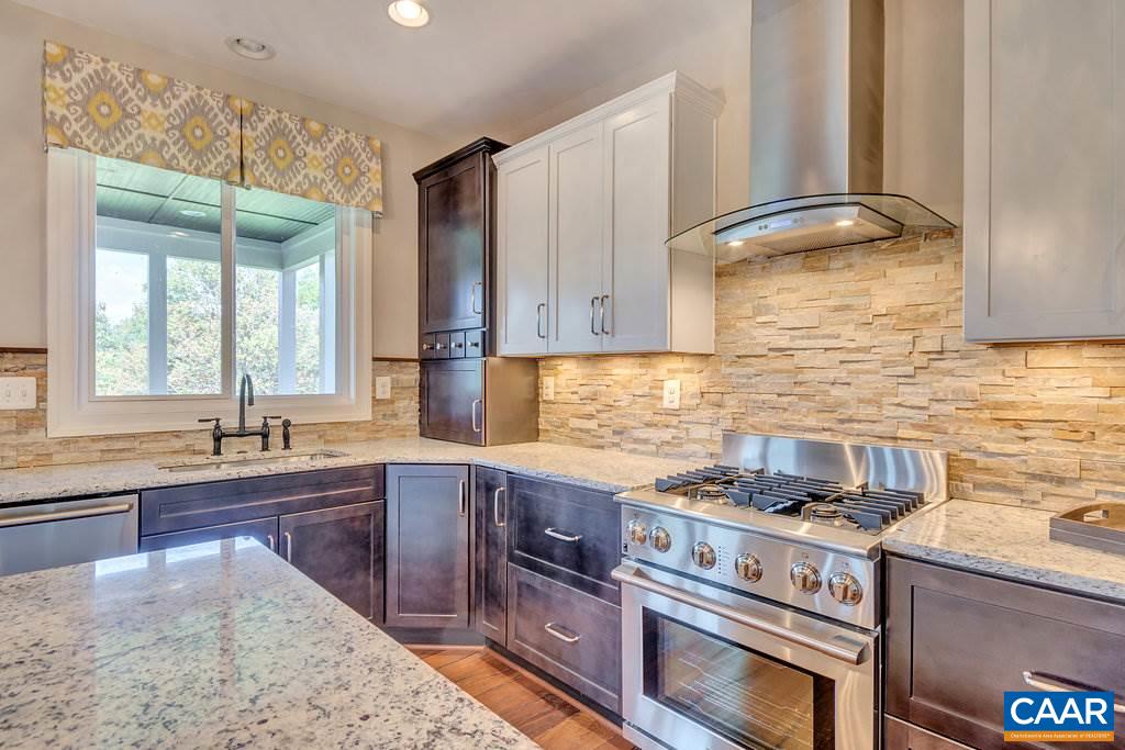 2128 Ridgetop Drive Charlottesville, VA 22903 - Photo 17 of 46 a kitchen with stainless steel appliances granite countertop a sink stove and refrigerator