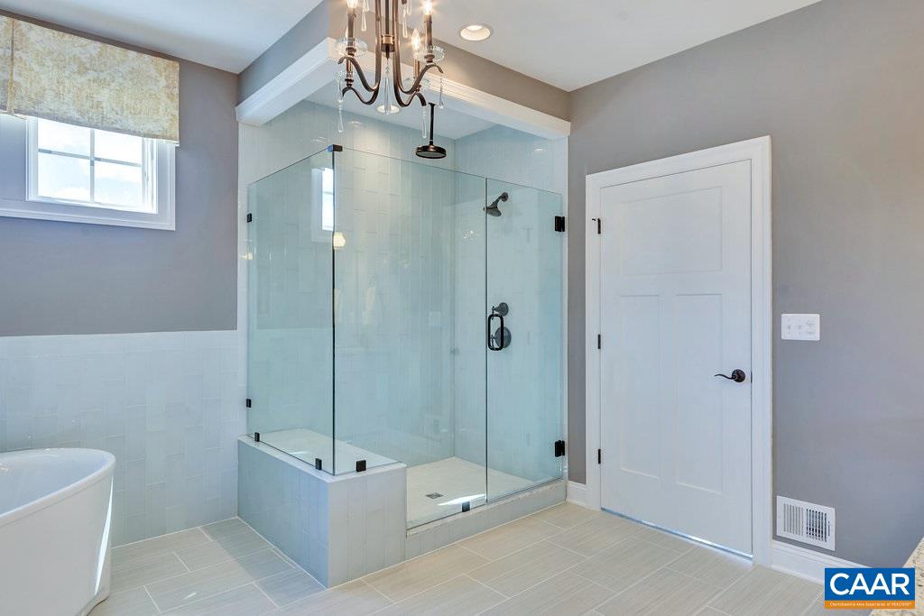 2128 Ridgetop Drive Charlottesville, VA 22903 - Photo 27 of 46 a bathroom with a tub shower sink and mirror