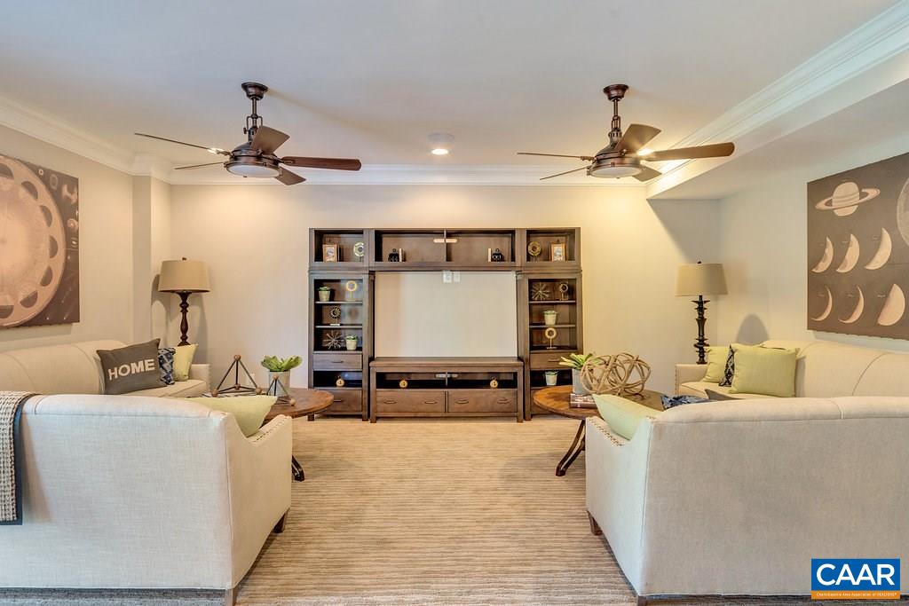 2128 Ridgetop Drive Charlottesville, VA 22903 - Photo 34 of 46 a living room with furniture a ceiling fan and a rug