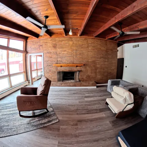 a view of a room with wooden floor