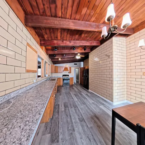 a view of a room with wooden floor