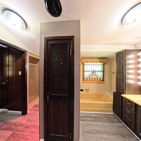 a view of hallway with stairs and wooden floor