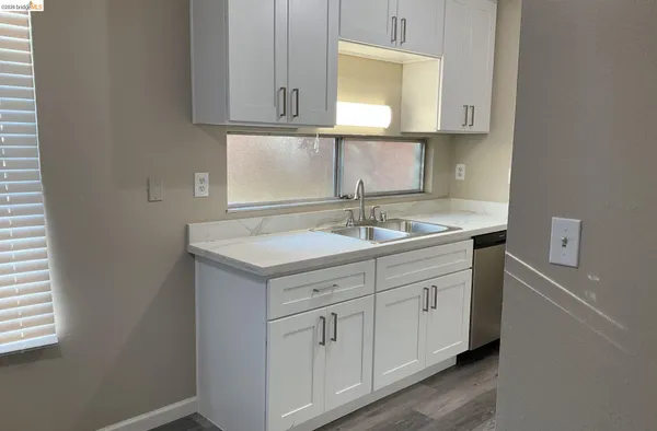 a bathroom with a sink vanity granite and a mirror
