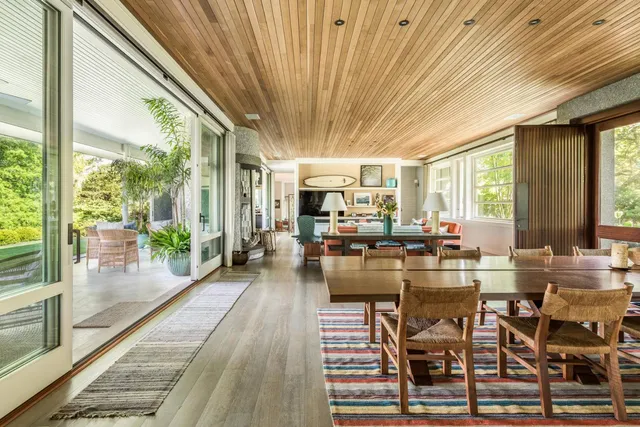 a view of a dining room with furniture wooden floor and a chandelier