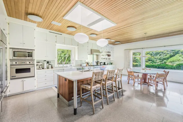 a kitchen with a table chairs and a refrigerator