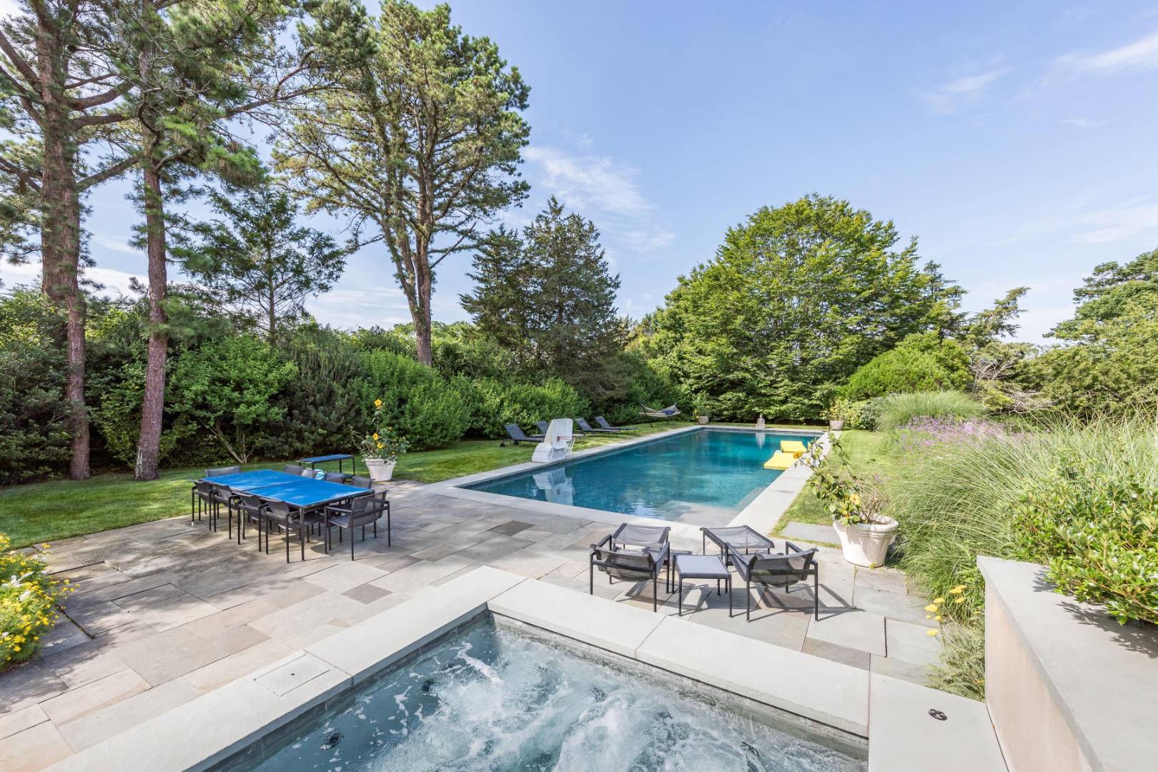 34 La Forest Lane East Hampton, NY 11937 - Photo 8 of 19 a view of a patio with chairs and a table