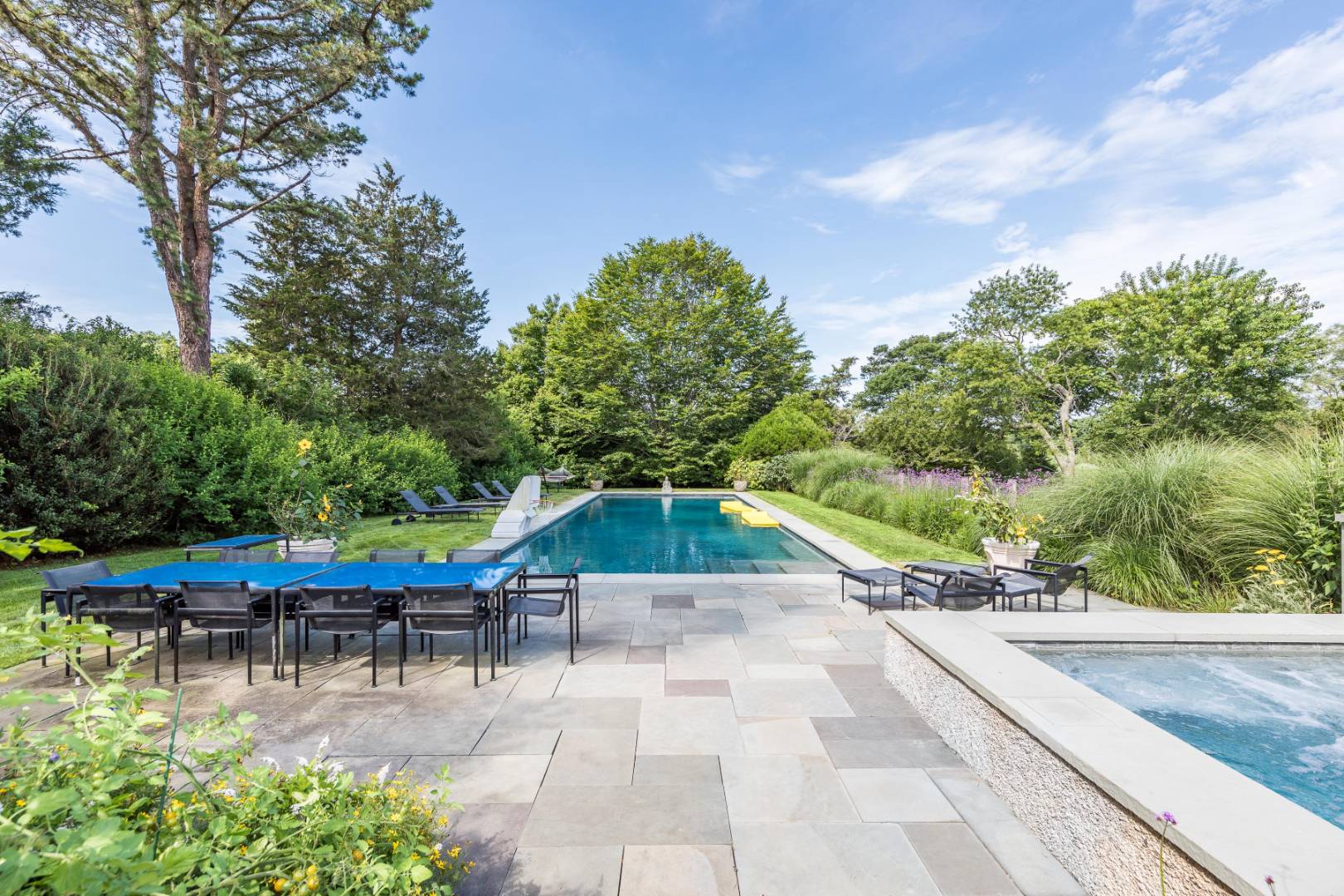 34 La Forest Lane East Hampton, NY 11937 - Photo 10 of 19 a view of swimming pool with table and chairs under an umbrella