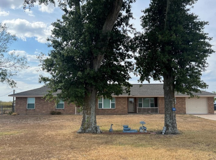 566 Schmidt Road Sealy, TX 77474 - Photo 3 of 20 a front view of a house with a yard and garage