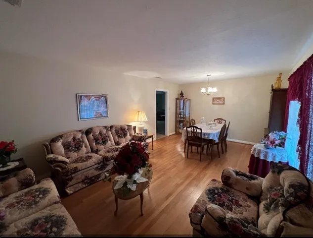 a bedroom with a bed dresser and a table