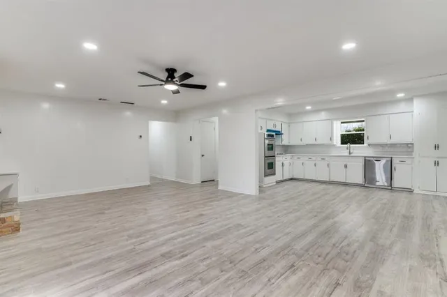 a view of a kitchen with a stove cabinets and wooden floor