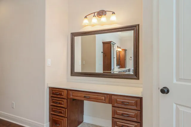 a bathroom with a sink a mirror and a vanity with a window