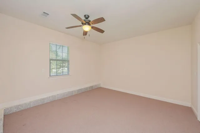 a bathroom with a granite countertop shower a sink and a mirror