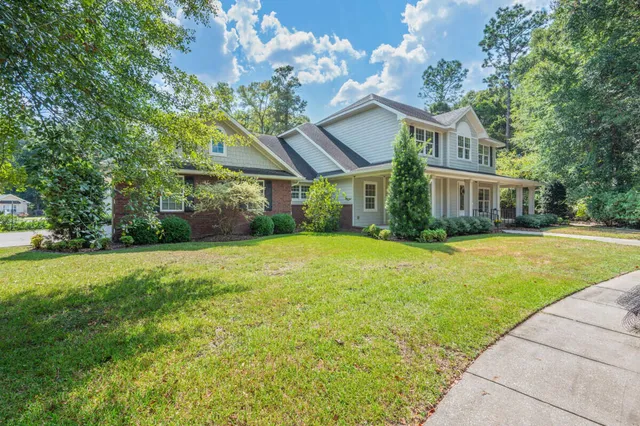 a large bathroom with a tub a sink and a large mirror
