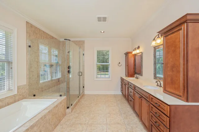 a kitchen with stainless steel appliances granite countertop a sink a oven a dining table and chairs with wooden floor