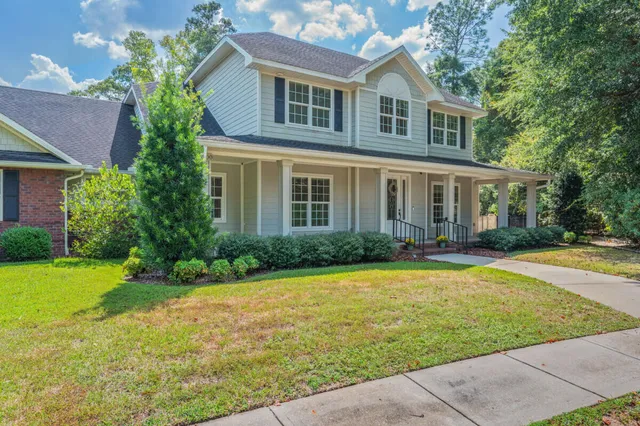 a bathroom with a granite countertop shower a toilet and a sink