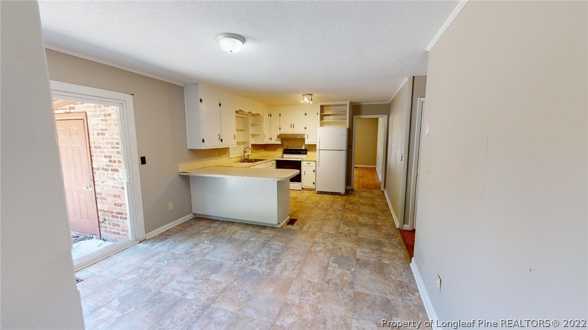 7608 Decatur Drive Fayetteville, NC 28303 - Photo 14 of 36 a view of a kitchen with microwave and a stove