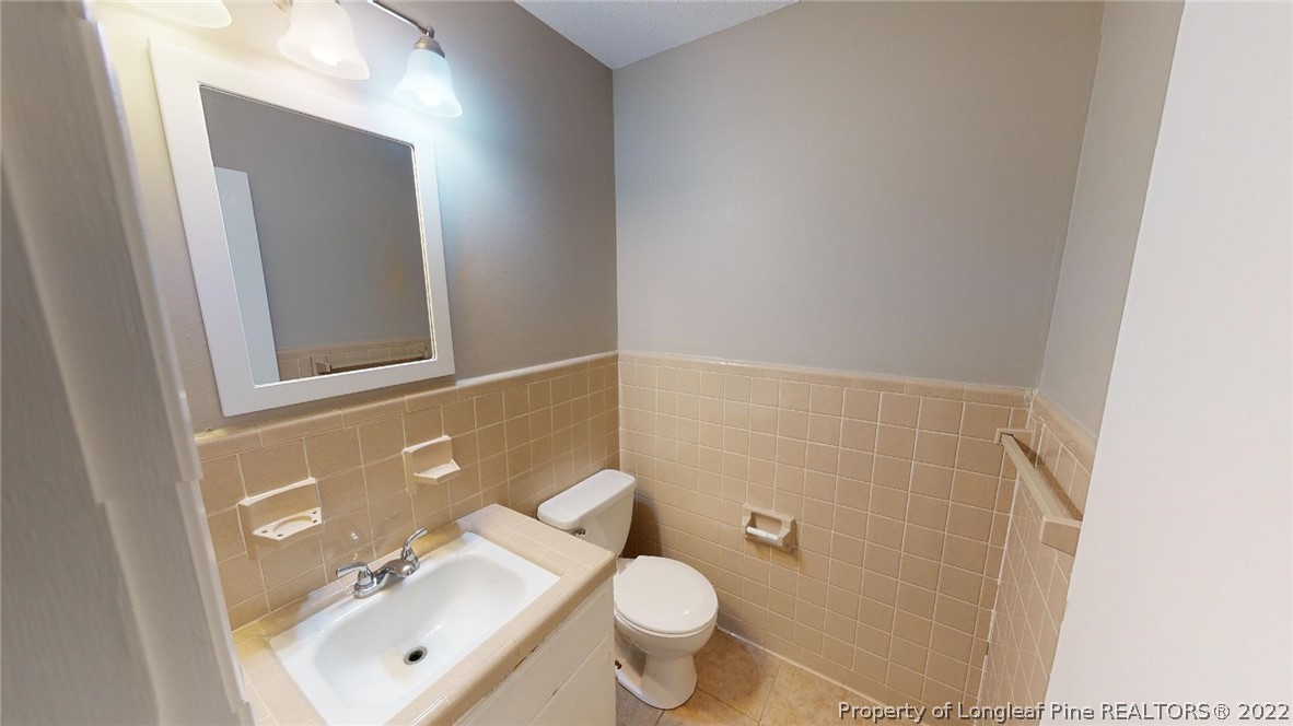 7608 Decatur Drive Fayetteville, NC 28303 - Photo 19 of 36 a bathroom with a toilet sink and mirror