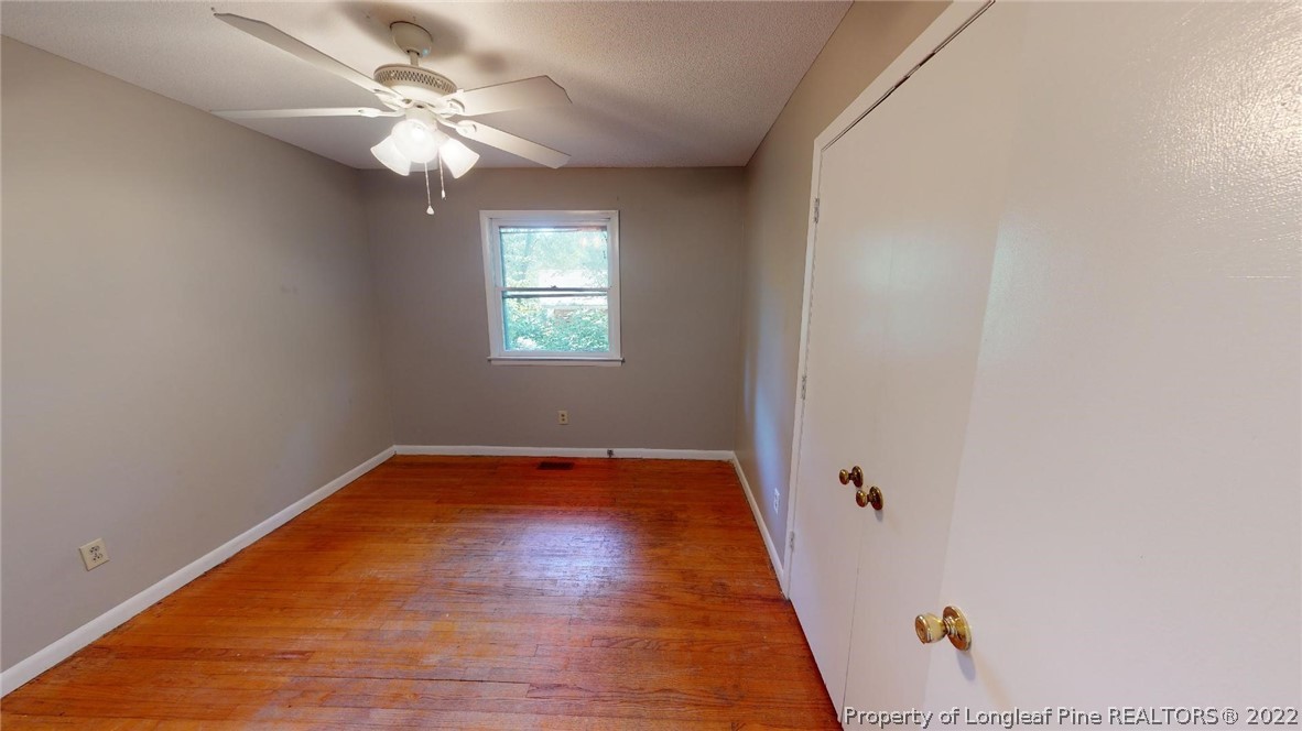 7608 Decatur Drive Fayetteville, NC 28303 - Photo 20 of 36 a view of an empty room with window and wooden floor