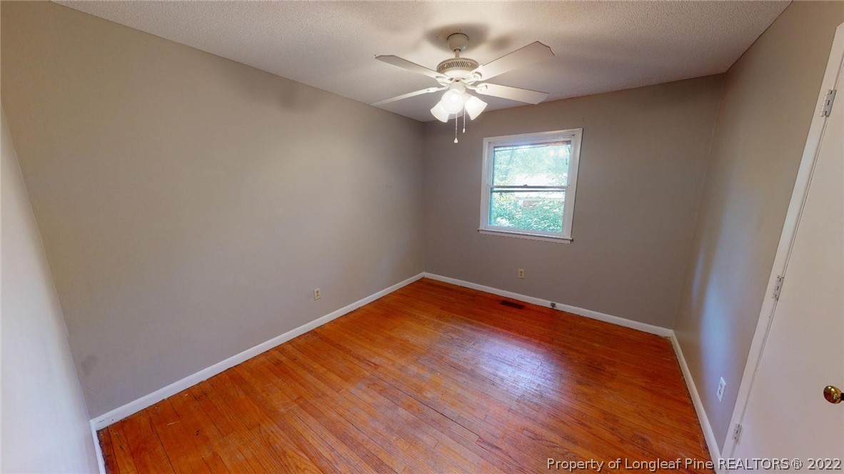 7608 Decatur Drive Fayetteville, NC 28303 - Photo 21 of 36 an empty room with wooden floor and windows