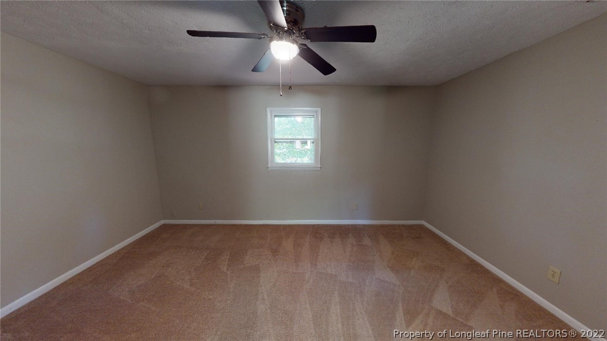 7608 Decatur Drive Fayetteville, NC 28303 - Photo 31 of 36 an empty room with a window and a fan