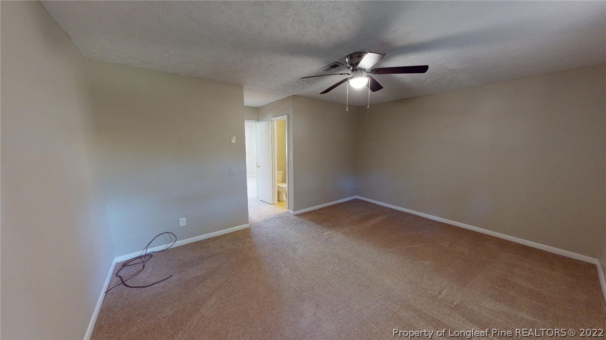 7608 Decatur Drive Fayetteville, NC 28303 - Photo 32 of 36 en empty room with windows and fan