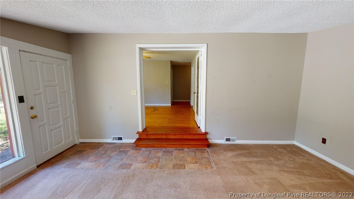 7608 Decatur Drive Fayetteville, NC 28303 - Photo 7 of 36 wooden floor in an empty room with a window