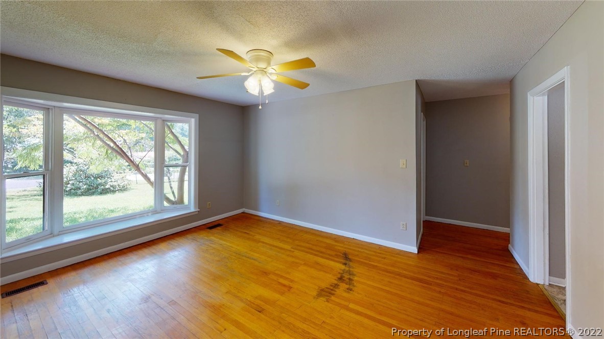 7608 Decatur Drive Fayetteville, NC 28303 - Photo 8 of 36 a view of an empty room with wooden floor and a window
