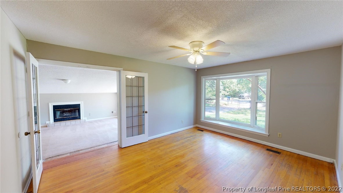 7608 Decatur Drive Fayetteville, NC 28303 - Photo 10 of 36 an empty room with wooden floor and windows