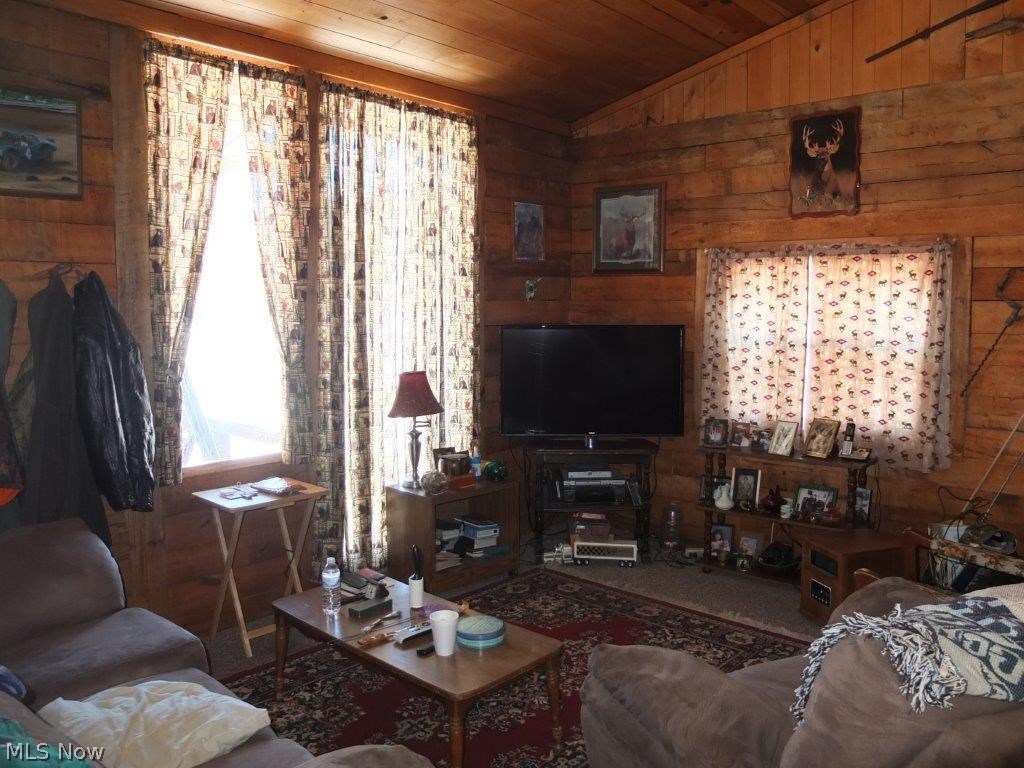 7739 Kendle Road Northwest Dover, OH 44622 - Photo 4 of 14 Living room with hardwood floor is open to the family room.