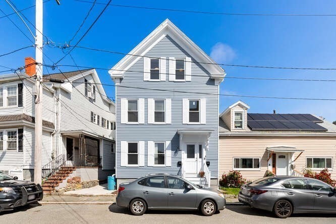 9 Foster Street, Unit 1 Gloucester, MA 01930 - Photo 2 of 13 a car parked in front of a building