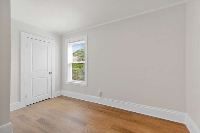 9 Foster Street, Unit 1 Gloucester, MA 01930 - Photo 9 of 13 a view of an empty room with wooden floor and a window