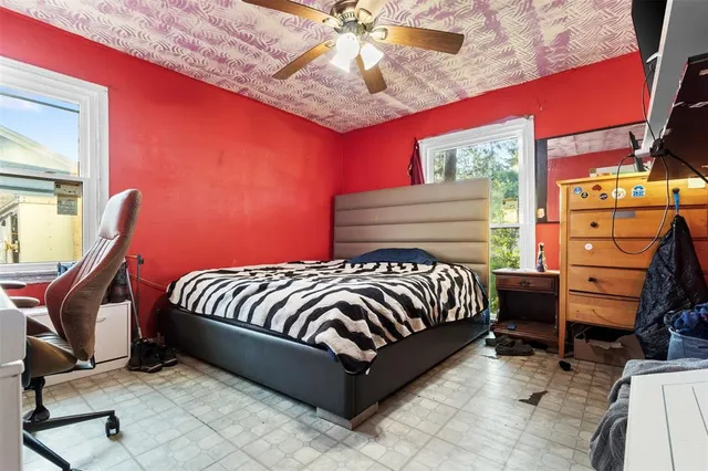 a bed sitting in a bedroom next to a lamp