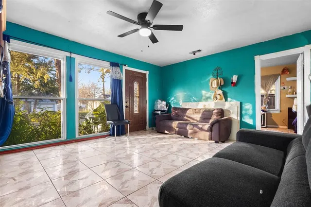 a bedroom with furniture and a large window