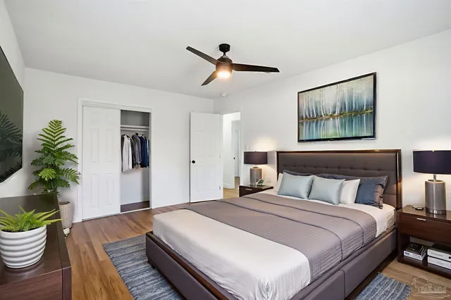 a bedroom with bed and a potted plant