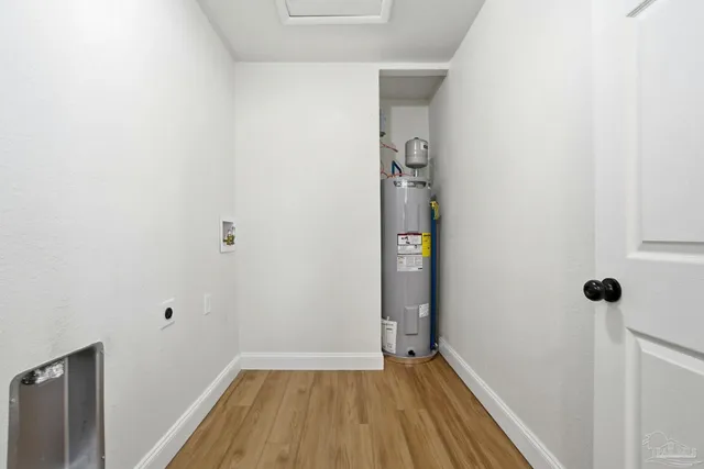 a view of a hallway with wooden floor and closet